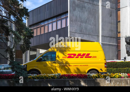 Varna, Bulgaria, September 13, 2019. Yellow DHL car parked near the city administrative building. Express courier delivery of mail, parcels, documents Stock Photo