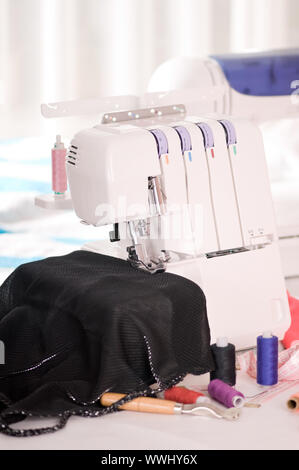 overlock and sewing machine is on the table Stock Photo