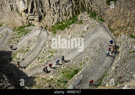 Hikers on a zigzag path Stock Photo