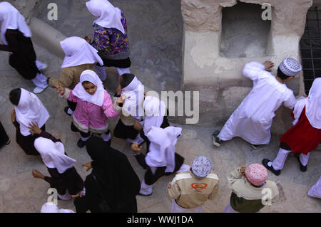 playing Omani girls and boys in traditional school clothes Stock Photo