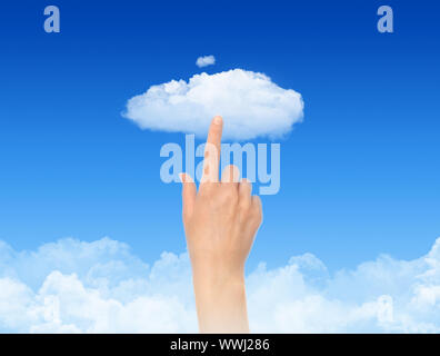 Woman hand touch the cloud against blue sky with clouds. Concept image on cloud computing and eco theme. Stock Photo