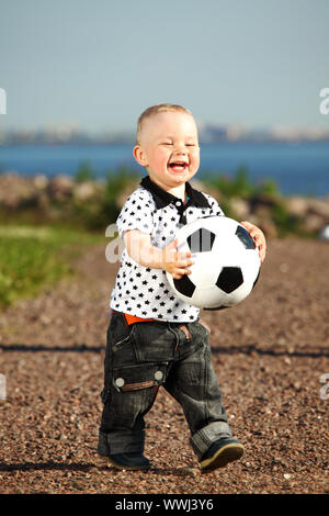 young smile boy play football Stock Photo