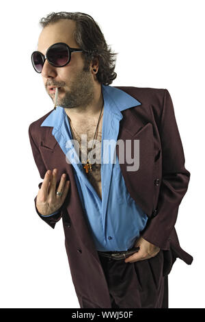 A sleazy guy, car salesman, Con man, retro suit wearing man with a smoke in his mouth and gesturing with his hand. Stock Photo