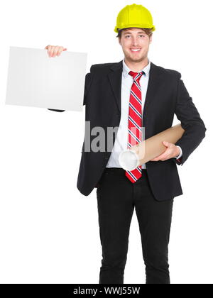 Engineer / architect man showing blank sign holding plans and wearing yellow construction work protective helmet. Young happy smiling caucasian male p Stock Photo