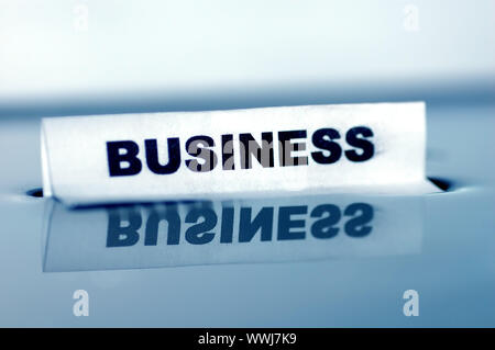 Card floating on water surface with printed word: BUSINESS Stock Photo