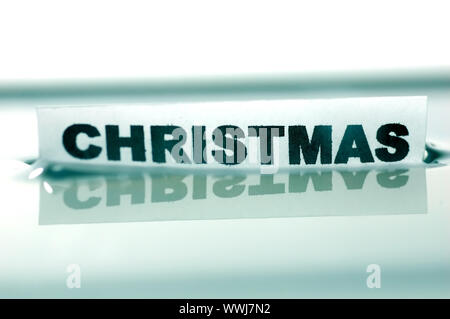 Card floating on water surface with printed word: CHRISTMAS Stock Photo