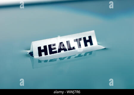 Card floating on water surface with printed word: HEALTH Stock Photo