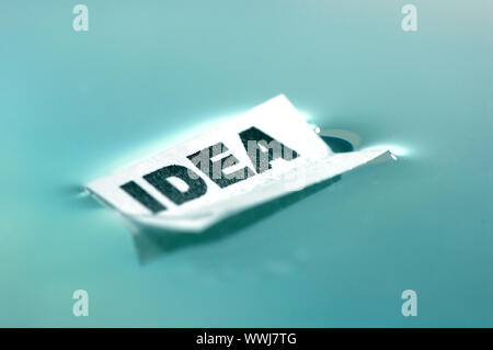 Card floating on water surface with printed word: IDEA Stock Photo