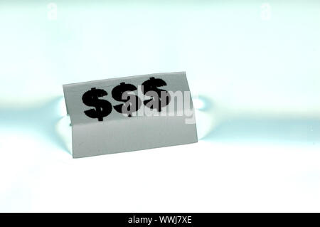 Card floating on water surface with printed: $$$ Stock Photo