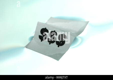 Card floating on water surface with printed: $$$ Stock Photo