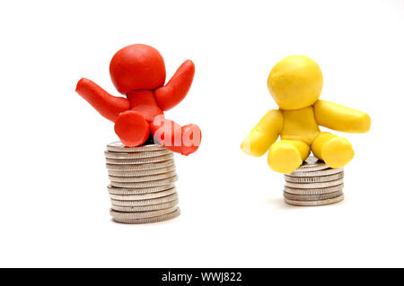 Plasticine figures sitting on coins piles. Winner and loser in business Stock Photo