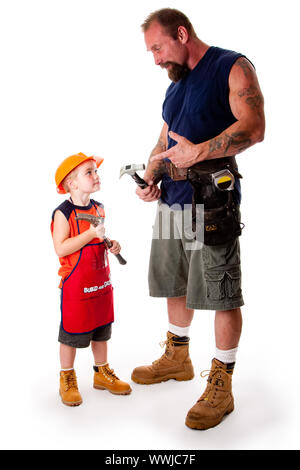 A big guy father with his son, carpenters, holding hammers while dad is explaining by pointing at his tool, isolated. Stock Photo
