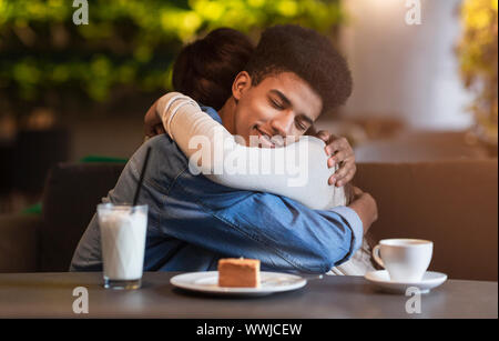 Happy beloved teen couple hugging with affection Stock Photo