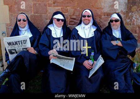 Four men dressed up as irreverant nuns during the 1940's weekend in Watchet, Somerset. Stock Photo