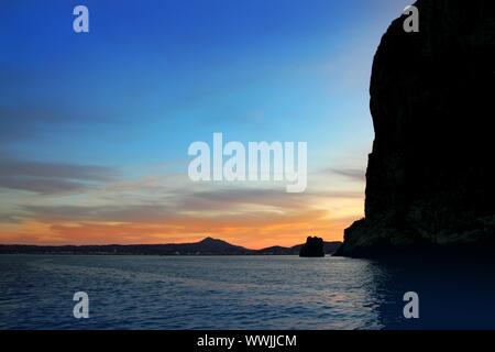 Cape San Antonio Javea Xabia sunset view from sea Mediterranean backlight in Alicante province Spain Stock Photo