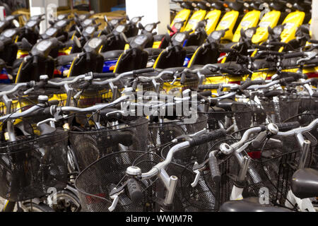 bicycles and scooter bikes rows in a renting shop pattern