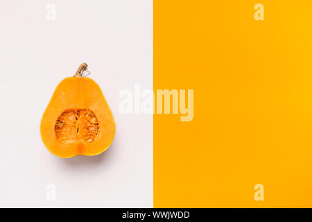 Half of pumpkin on different colors background Stock Photo