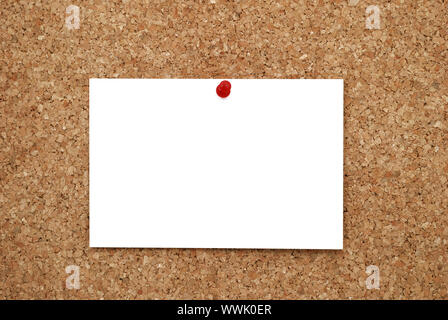 white sheet of paper pinned to cork  bulletin board Stock Photo