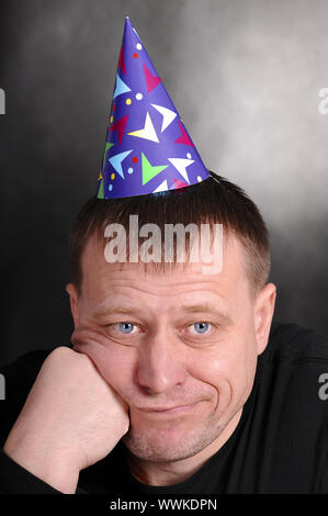 a sad man in the festive hood Stock Photo