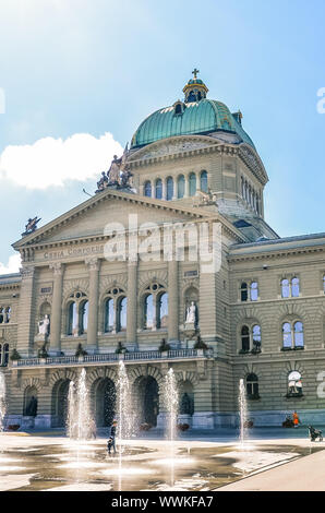 Bern, Switzerland - August 14, 2019: Building of the Swiss Parliament photographed from outside with people walking on the adjacent square. Government, administration. Swiss confederation. State. Stock Photo