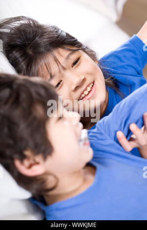 Big sister taking care of her disabled little brother Stock Photo