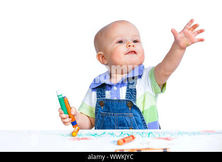 Portrait clouse-up of little sweet boy draws with crayons in red, isolated on white Stock Photo