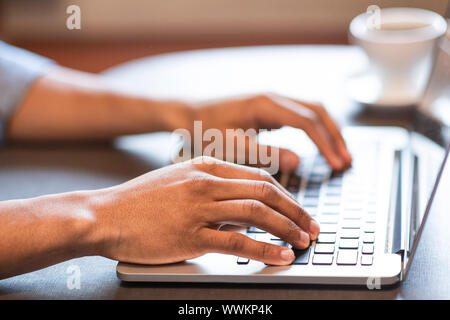 Male hands typing programming code or text on laptop Stock Photo