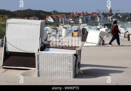 Rostock, Germany. 16th Sep, 2019. One beach chair has fallen over, others stand crooked, because the strong wind of the past days has blown away the sand under the baskets. Also the other beach chairs are empty, it is too windy and too cold. Credit: Bernd Wüstneck/dpa-Zentralbild/dpa/Alamy Live News Stock Photo