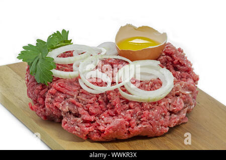 minced meat with onion rings, parsley and egg Stock Photo