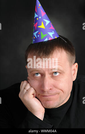 a sad man in the festive hood Stock Photo