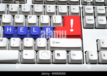 the blue keys on the keyboard is written the word help, with an exclamation mark on the big button Stock Photo