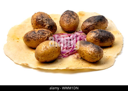 Small grilled potatoes on lavash with red onions on a white background Stock Photo