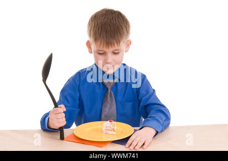 child with a large spoon isolated on white background Stock Photo