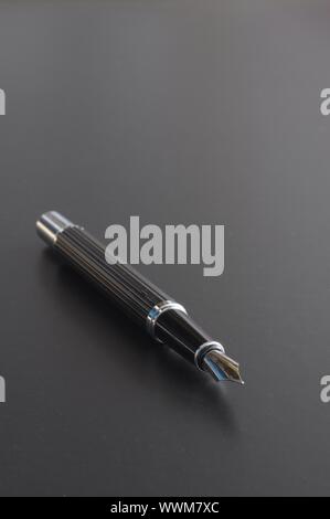 pen showing communication contact us or mail concept on black background Stock Photo