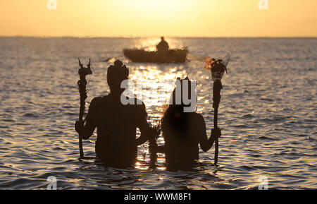 EMBARGOED TO 0001 TUESDAY SEPTEMBER 17 Ceara Carney,and Louis Heath, of Extinction Rebellion Ireland, dressed as ‘sea gods’, at Killiney Bay Dublin, as activists have demanded the Irish Government turn the tide on its bid to tackle climate change. Stock Photo