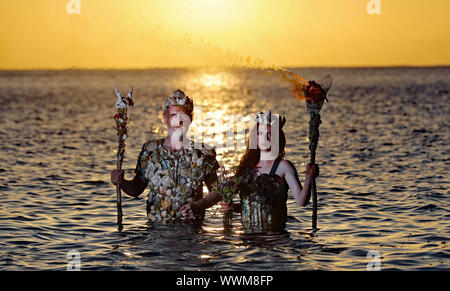 EMBARGOED TO 0001 TUESDAY SEPTEMBER 17 Ceara Carney,and Louis Heath, of Extinction Rebellion Ireland, dressed as ‘sea gods’, at Killiney Bay Dublin, as activists have demanded the Irish Government turn the tide on its bid to tackle climate change. Stock Photo