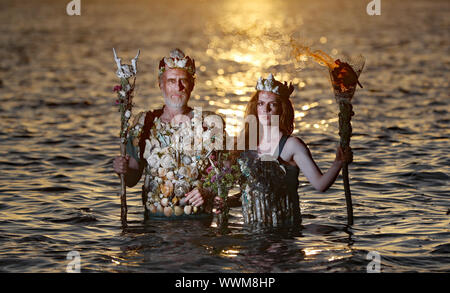 Ceara Carney,and Louis Heath, of Extinction Rebellion Ireland, dressed as â€˜sea godsâ€™, at Killiney Bay Dublin, as activists have demanded the Irish Government turn the tide on its bid to tackle climate change. Stock Photo