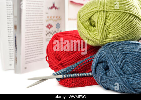 Yarn needles pattern and knitting on white Stock Photo