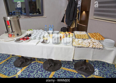 Luxury hotel restaurant deserts open buffet. Table with deserts, Sweet desserts and pastries on the table .barley, chopped fruit, glass. Stock Photo