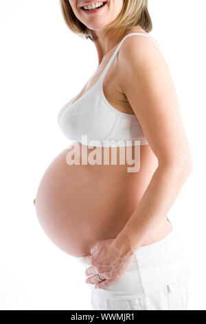 Pregnant woman with exposed belly smiling Stock Photo