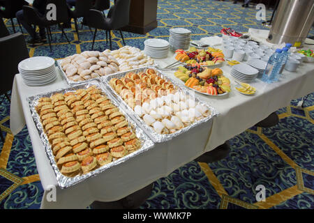 Luxury hotel restaurant deserts open buffet. Table with deserts, Sweet desserts and pastries on the table .barley, chopped fruit, glass. Stock Photo