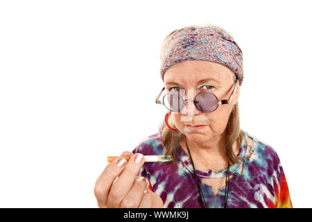 Senior hippie lady in tie dye with cigarette Stock Photo
