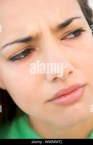 Head shot of woman scowling Stock Photo