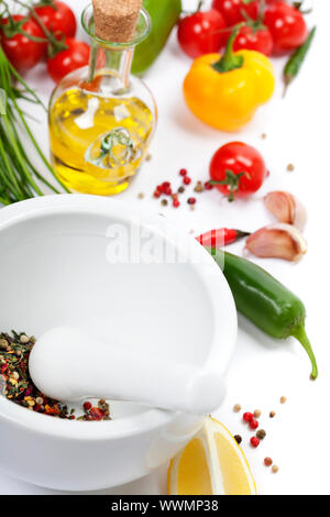 Ceramic Mortar with Pestle, fresh spices and vegetables Stock Photo