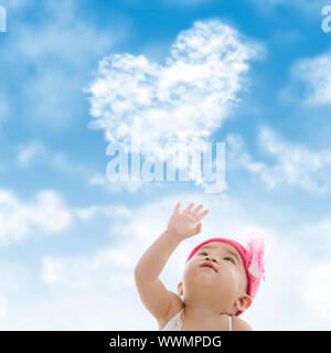 Baby girl hand towards sky Stock Photo