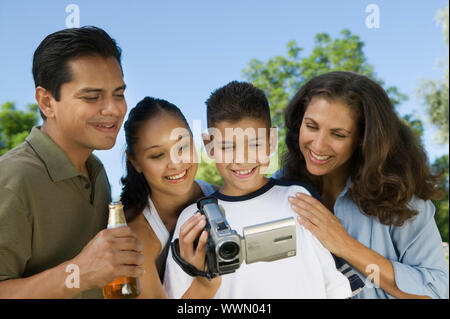 Family Watching Video Camera Stock Photo