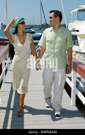 Happy Couple Walking on Dock Stock Photo