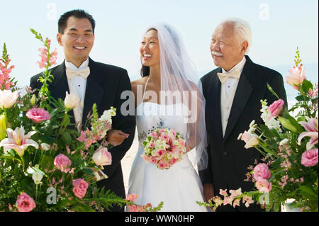 Bride and Groom With Father Stock Photo