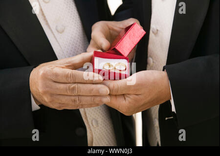 Groom and Father Holding Wedding Rings Stock Photo