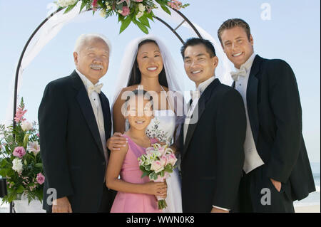 Bride and Groom With Best Man and Family Stock Photo